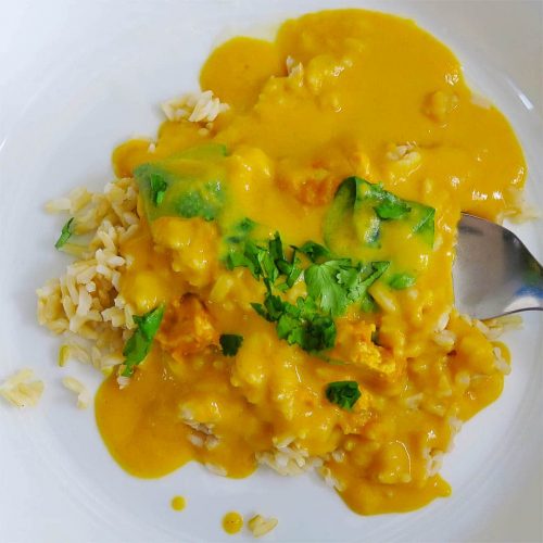 Butternut Squash Green Curry in white bowl with fork