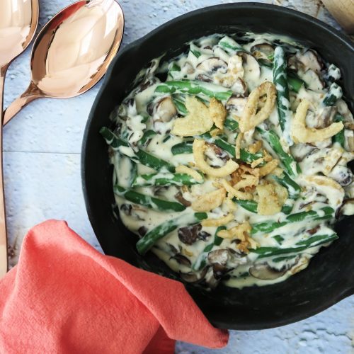 Top-down shot of Skillet Green Bean Casserole with green beans, a creamy sauce made with the Mother Mix and crunchy fried onions.