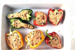 Green, red, and yellow peppers, cut from stem to tip, and stuffed with rice, beans, tomatoes, and chipotle cheese sauce mix.