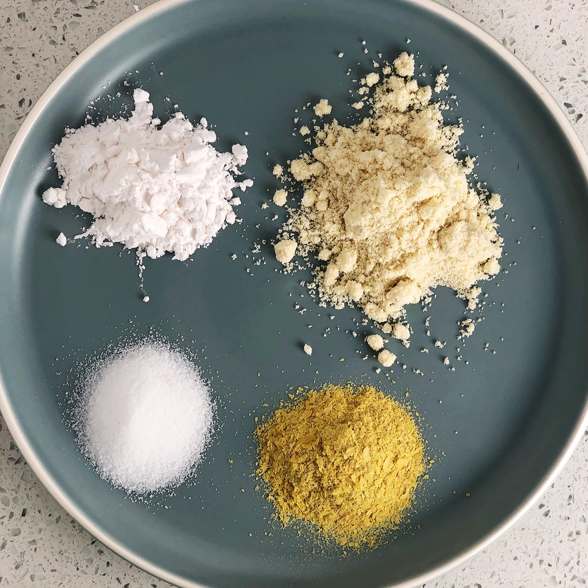 Top-down view of Mother Mix ingredients: tapioca starch, almond flour, nutritional yeast, salt