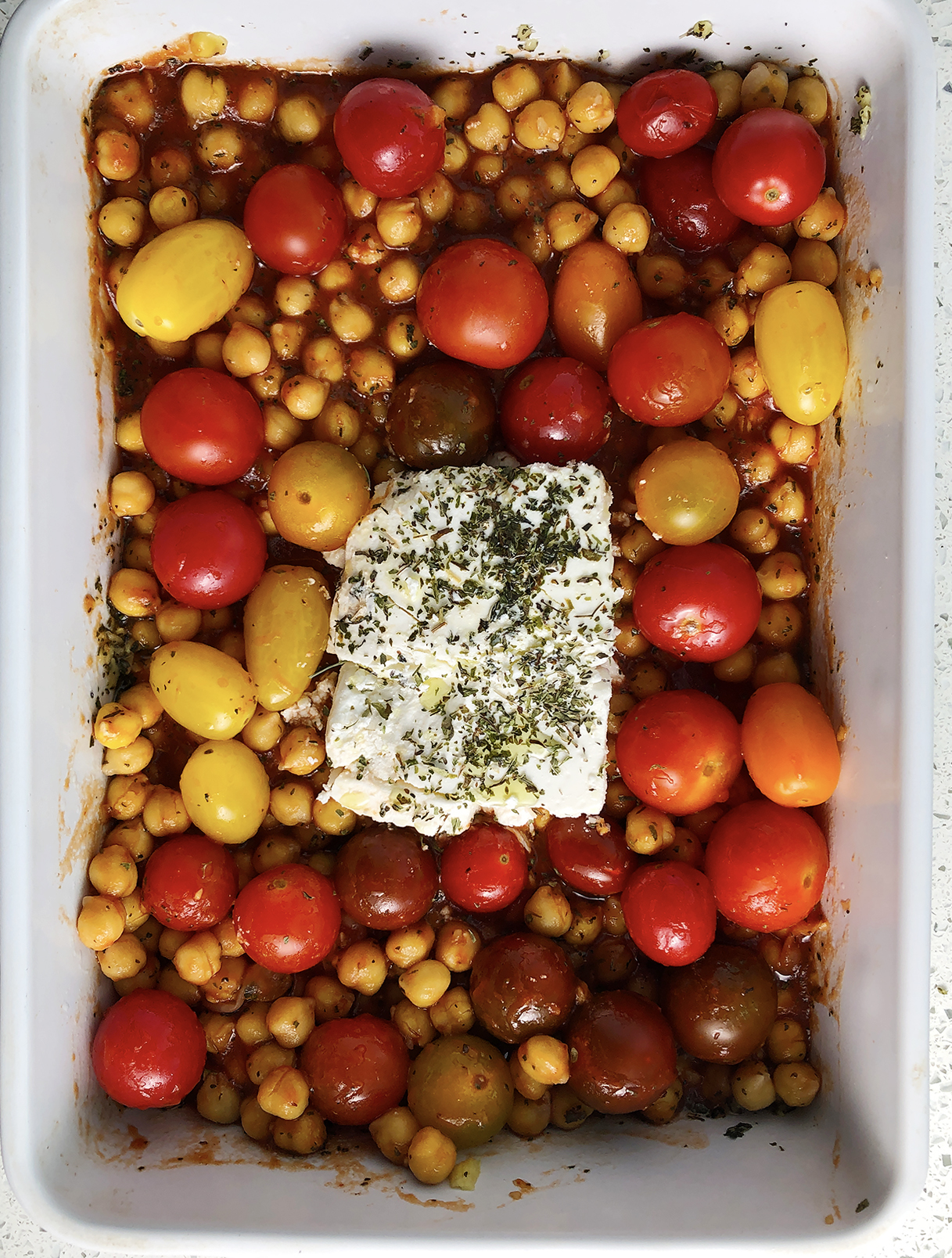 Top-down view of Chickpea Feta Bake in the casserole dish, before it goes in the oven