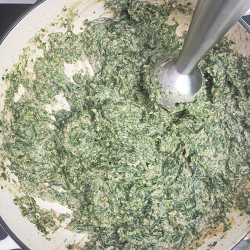 Use a hand (immersion) blender to blend the spinach to your desired consistency.