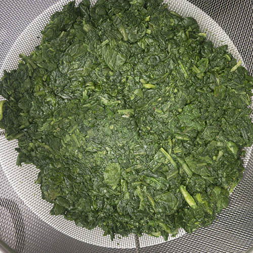 Cooked spinach with water pressed out. Making Indian Spiced Spinach (Saag).