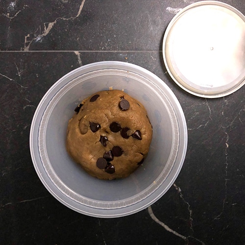 Ball of cookie dough in a plastic container