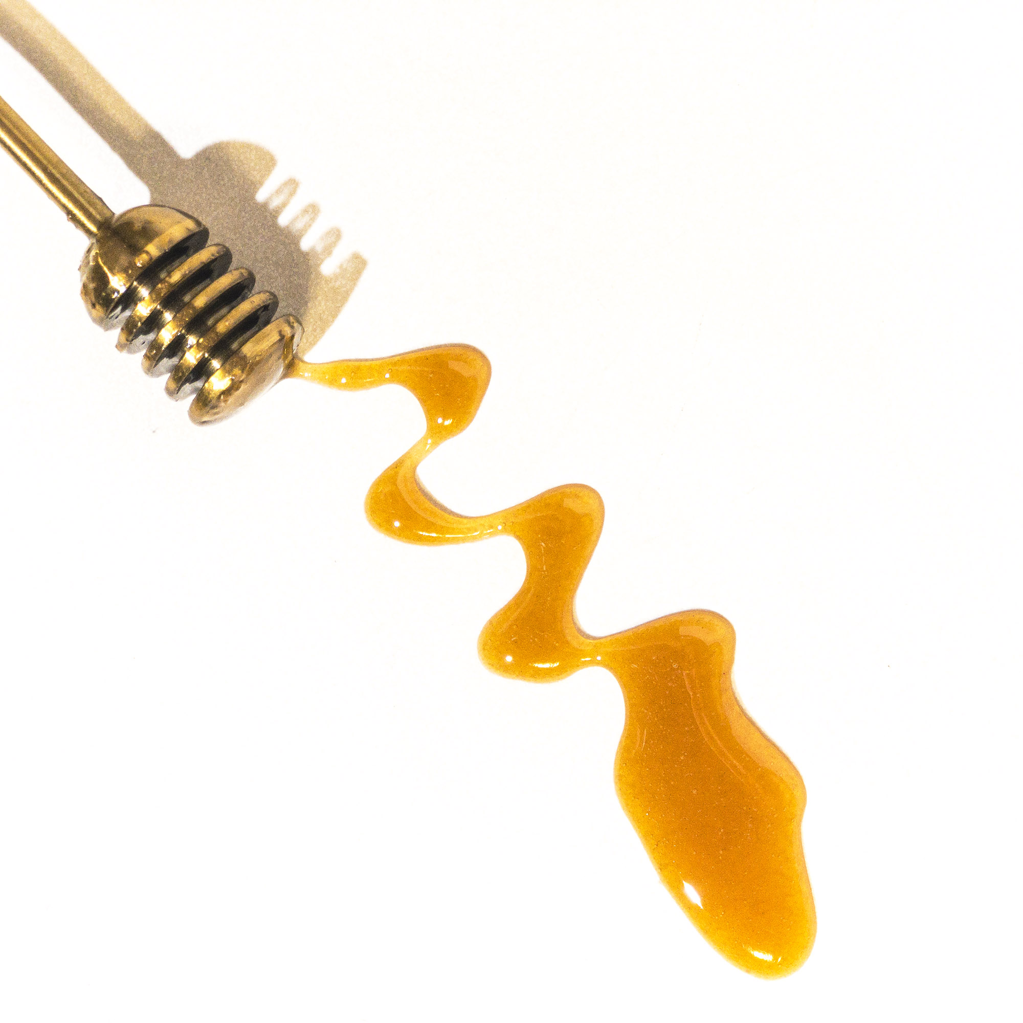 honey dripping from a honey-dipper