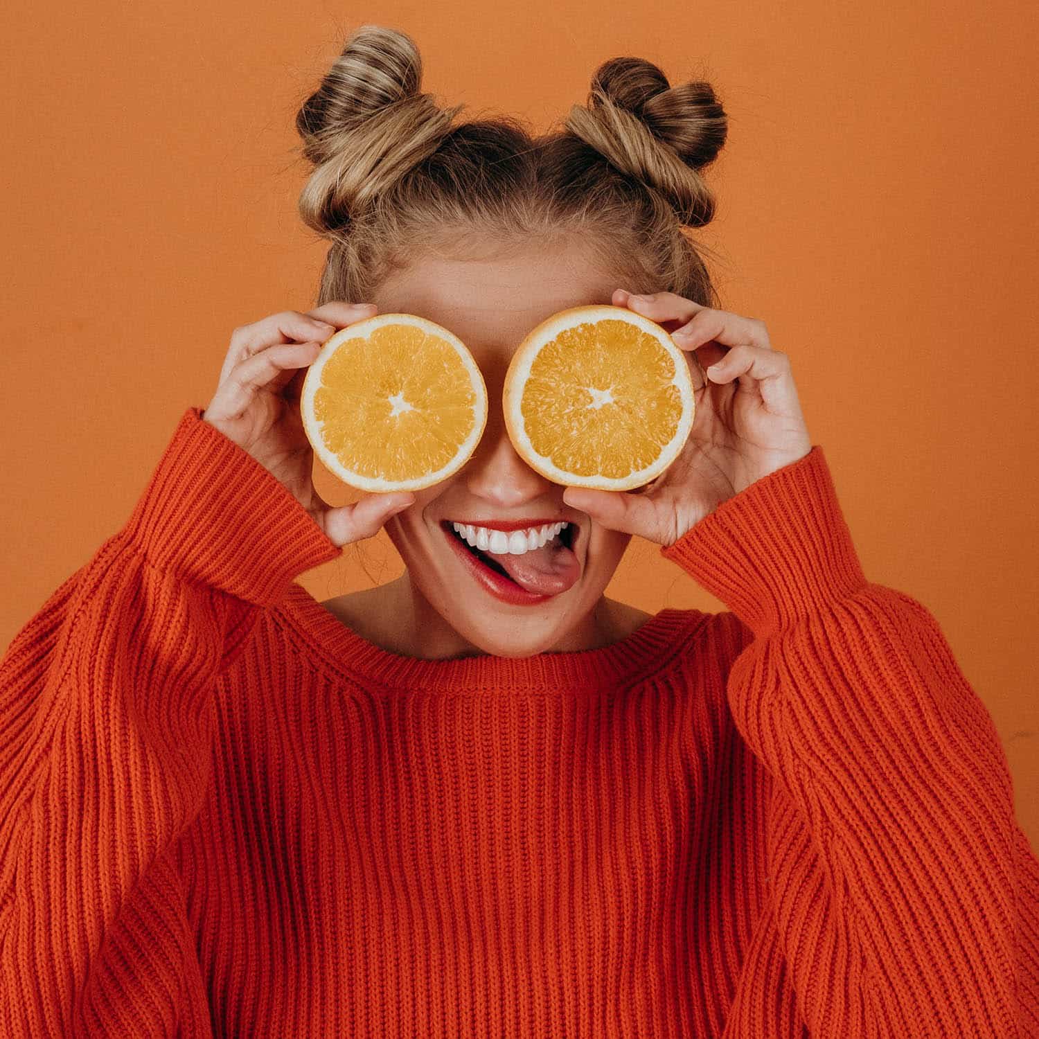 decorative image of woman with orange slices in front of her eyes