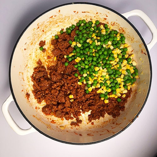 Top-down view of peas and corn added to Beyond Beef mixture. 