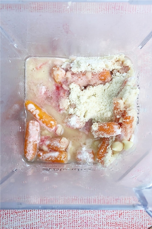 Top-down view of ingredients for Blood Orange and Carrot Cheesecake in the blender