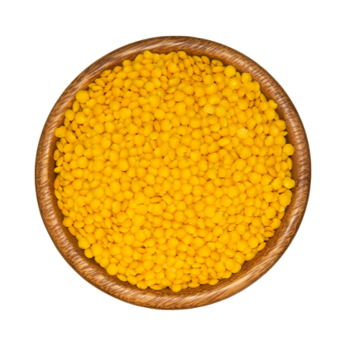 Top down view of yellow lentils in a wooden bowl