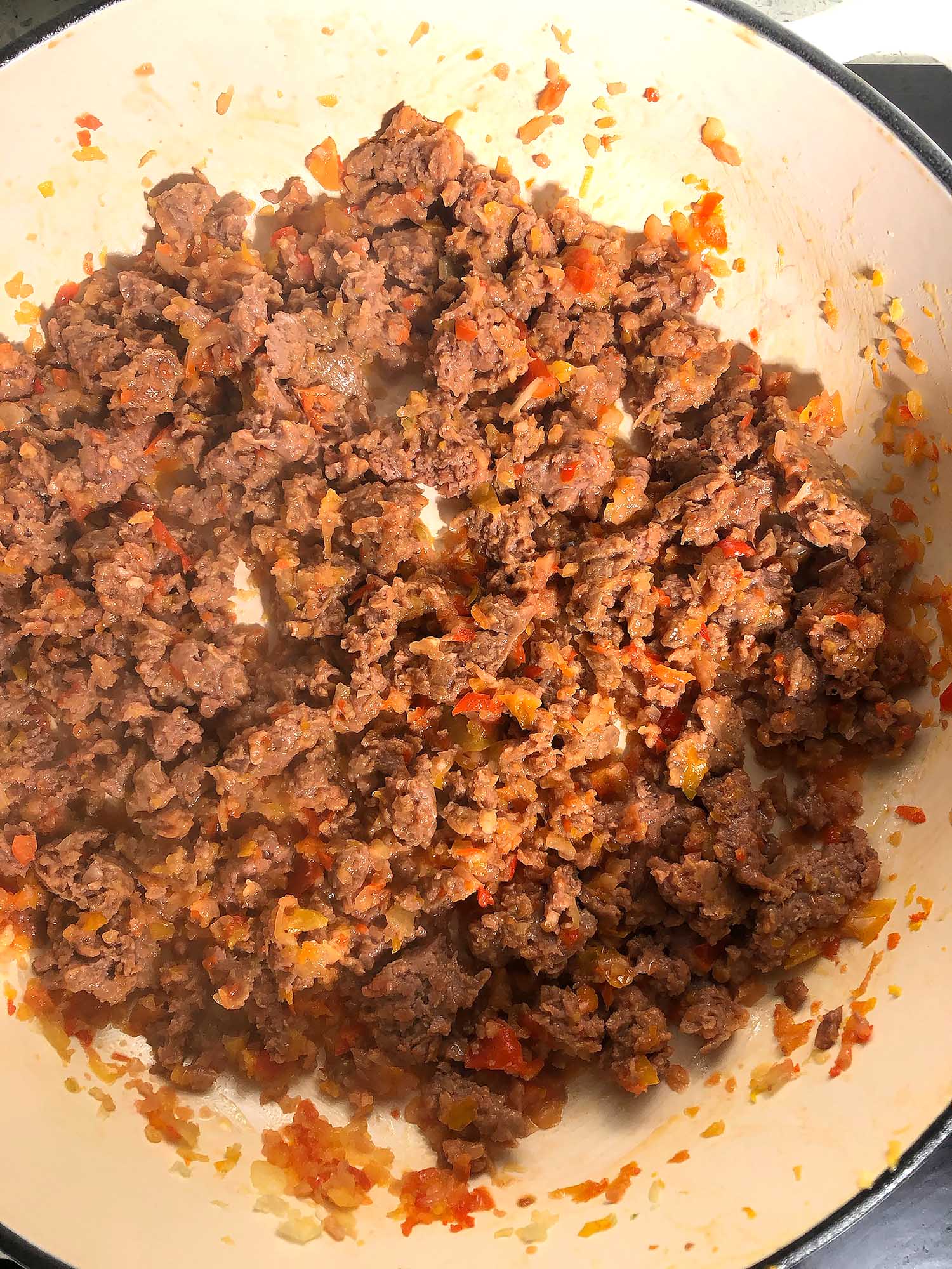 Top-down view of Beyond Meat cooked with peppers, onions, and garlic