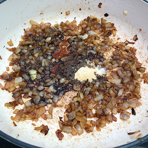 Adding balsamic vinegar, onion, and salt to caramelized onions