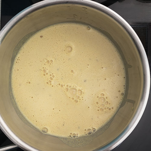 Top-down view of vegan queso in the saucepan, before heating it.