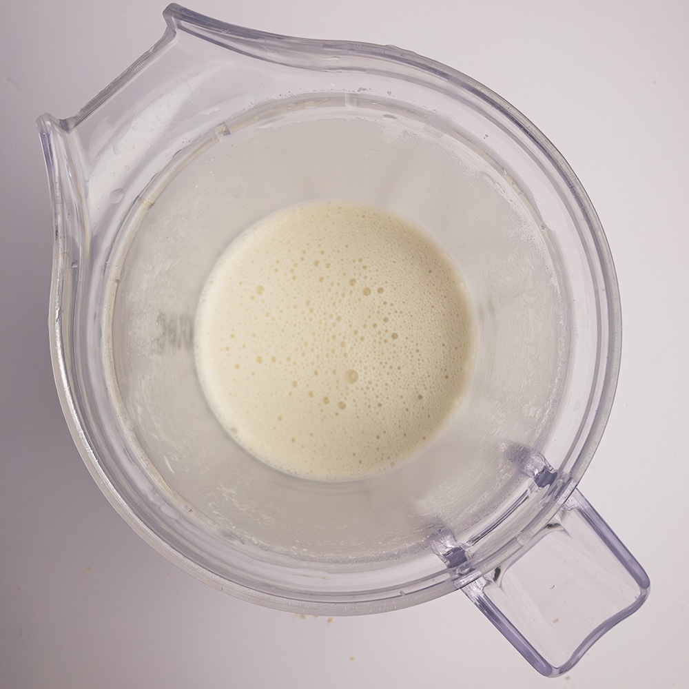 Top down view of a blender jug with blended Mother Mix sauce