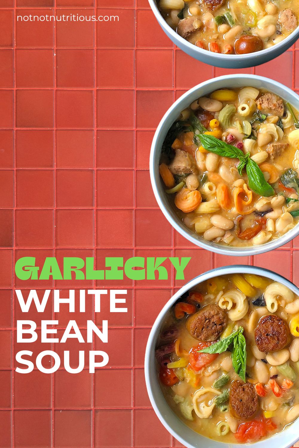 Pin for Garlicky White Bean Soup with plant-based sausage. Three bowls of soup on red tile.