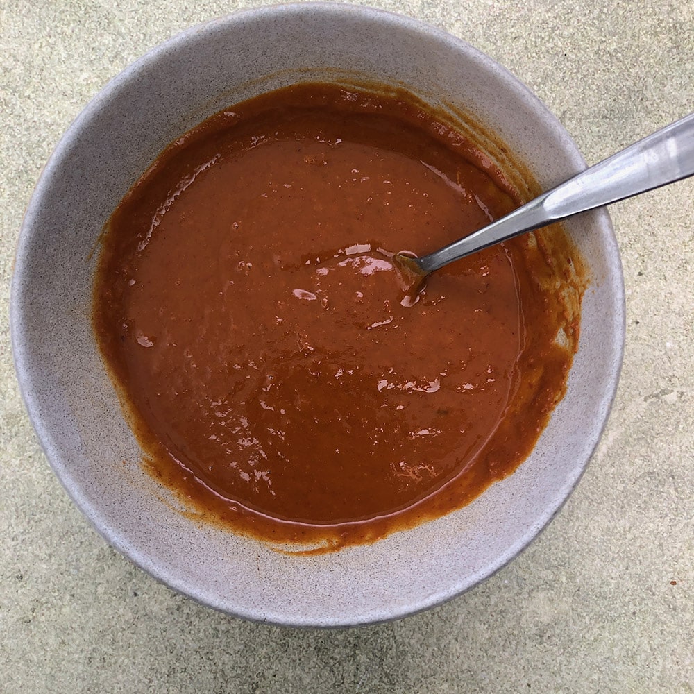 Top-down view of bowl with Spicy Thai-Inspired Peanut Sauce 