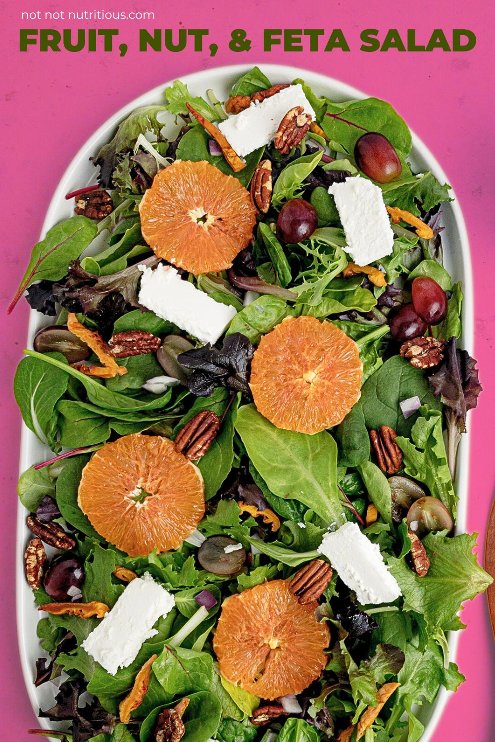 Pin for Fruit, Nut and Feta Salad, with a top-down view of the salad against a bright pink background