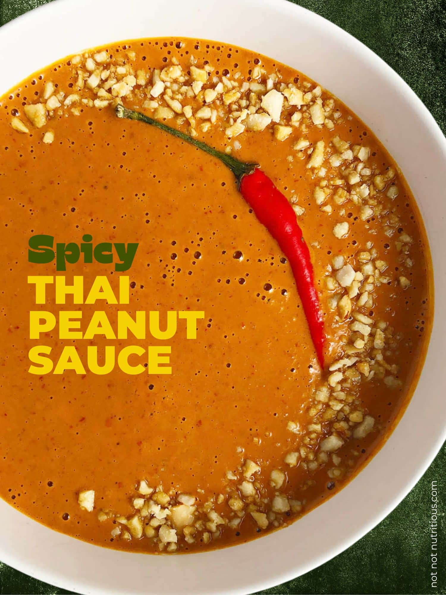 Pin for Spicy Thai-Inspired Peanut Sauce, with peanut sauce topped with crushed peanuts in a white bowl.