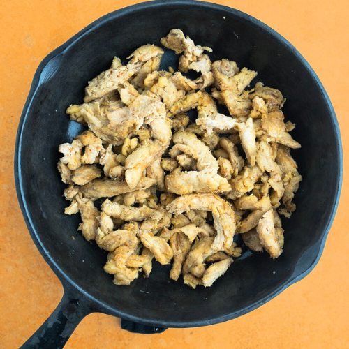 Top-down view of cooked soy curls in a frying pan